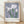 Framed Japandi botanical poster of a lavender iris with green stem and leaves on cream background, inspired by Ogawa Kazumasa's minimalist style.