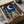 Peaceful framed poster showcasing an ornamental mosque scene with crescent moon, delicate arabesques, and botanical flourishes in navy, turquoise, cream, and warm gold tones.