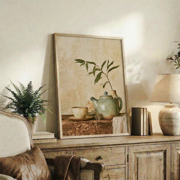 Japandi zen still life art print with soft watercolor teapot, cup, and botanical elements in sage, warm brown, and pale ochre creating a meditative home décor piece.