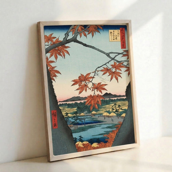 Traditional Japanese landscape print in warm earth tones showing delicate maple branches in fall, with a distant temple, forested hillside, and tranquil blue water in soft Japandi aesthetic.