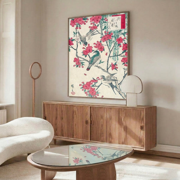 Serene woodblock print depicting birds perched amid cherry blossoms and willow branches in traditional Japanese style, combining deep teal, soft rose, cream, and expressive black ink.