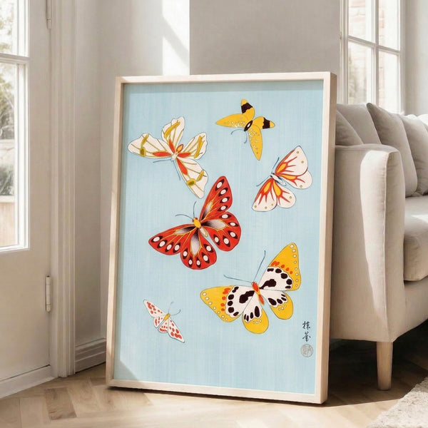Delicate Japanese-inspired butterfly study in gold and red with pale blue background and precise black linework, capturing a peaceful natural aesthetic.