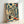 Framed modern woodblock print of a peaceful interior corridor lined with traditional Japanese ceramics and vessels, featuring a calming palette of cream, dark teal, and warm gold accents.