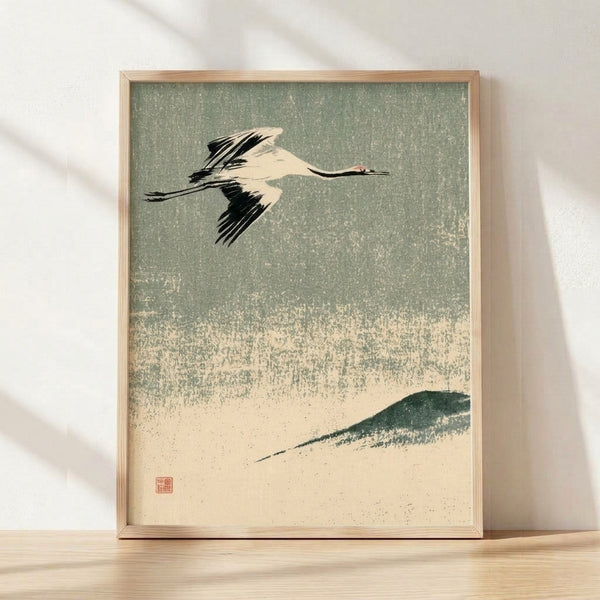 Japanese woodblock-style art print of a red-crowned crane in graceful flight over misty mountains and forest, rendered in sage green, cream, and black with minimalist elegance.