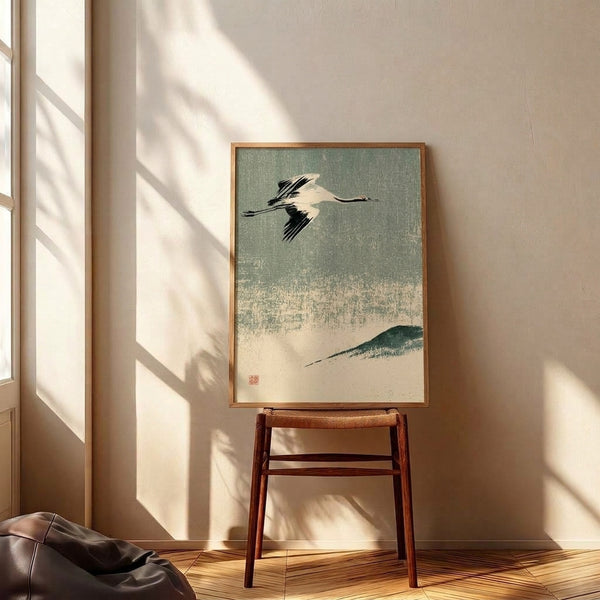Minimalist crane art print with contemplative mood, featuring a bird in flight over mountain scenery in sage green and cream tones with Japanese artistic influence.