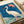 Framed art print in classic ukiyo-e style showing a graceful bird alongside red spider lily blooms in a palette of cream, burnt orange, blue, and soft green tones.