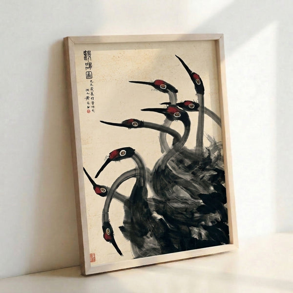 Framed poster displaying a graceful crane rendered in charcoal and burgundy tones using classic Japanese ink wash technique on pale cream ground.