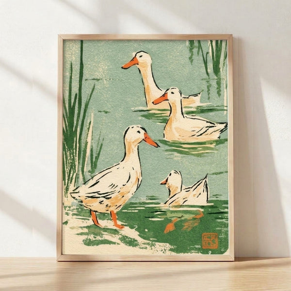 Serene Japanese woodblock-style poster depicting ducks nestled among reeds in a peaceful pond, rendered in soft sage green, cream, and pale yellow tones with dark green accents, framed on a wall.