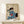 Wall art print in traditional Japanese woodblock technique featuring a geisha in patterned kimono attending to her reflection, suffused with contemplative mood and classic blue and cream coloring.