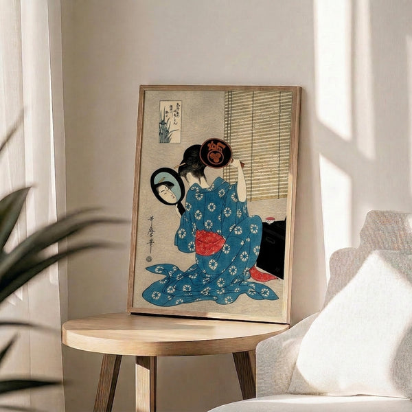 Framed traditional woodblock print capturing a geisha's intimate moment of self-reflection at her mirror, dressed in ornate kimono against a composition of deep blue, cream, and black.