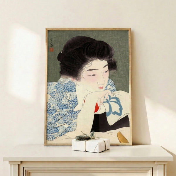 Framed Ukiyo-e style artwork showcasing a geisha with fan, rendered in muted sage green and cream with dramatic indigo blue, capturing contemplative grace through woodblock artistry.