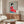 Elegant wall art print in the style of Showa woodblock prints, capturing a graceful geisha in crimson kimono with refined details in red, blue, black, and neutral tones.