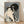 Japanese woodblock print of a geisha in traditional kimono wiping her face, rendered in cream, black, gray, pink and blue tones with elegant, contemplative mood.