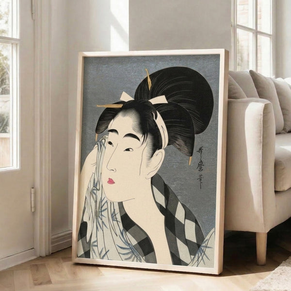Vintage-inspired Japanese wall art of a geisha wiping her face, featuring delicate linework and a restrained color scheme of cream, black and blue.