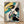 Elegant geisha in ornate kimono holding a parasol, rendered in traditional Japanese woodblock style with soft yellow, teal, black and cream tones.