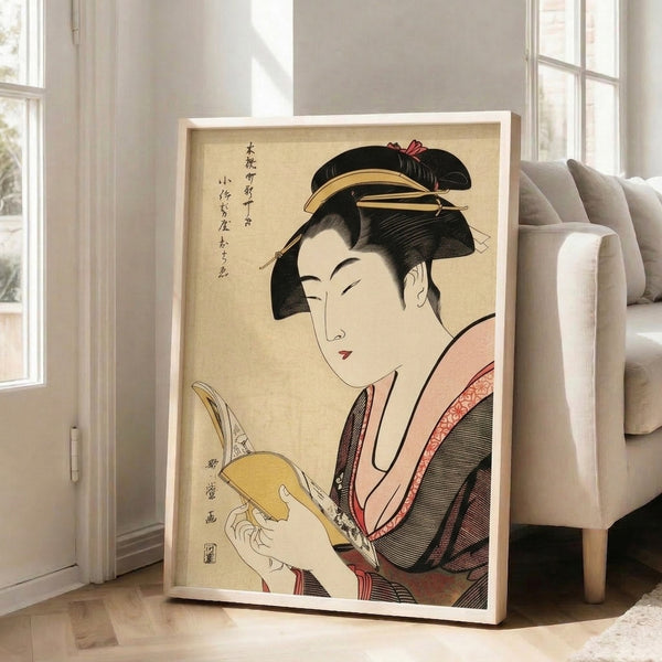 Traditional Japanese woodblock print depicting a refined geisha absorbed in literature, adorned in richly detailed kimono with gold embellishments and hair ornaments, framed and displayed on a wall.