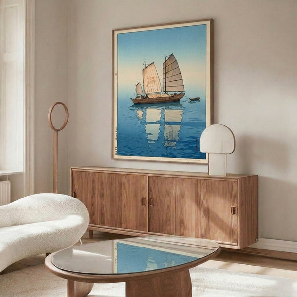 Japanese woodblock maritime artwork portraying a traditional sailing vessel and its reflection in serene waters, featuring elegant cream, pale yellow, and blue coloring.