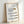 Framed poster of kitchen knives illustrated with clean black lines in minimalist japandi style against a cream colored background.
