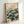 Tranquil framed art print showing a water lily and lotus plant in soft rose and sage green hues against cream, inspired by traditional Japanese woodblock printing techniques.