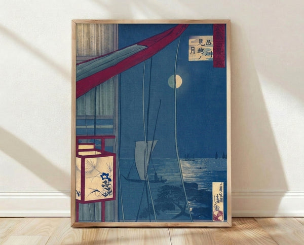 Serene Japanese woodblock print depicting a nighttime moon-viewing scene with a sailboat on indigo waters, traditional architecture, and glowing lantern in cream and crimson tones, framed as wall art.