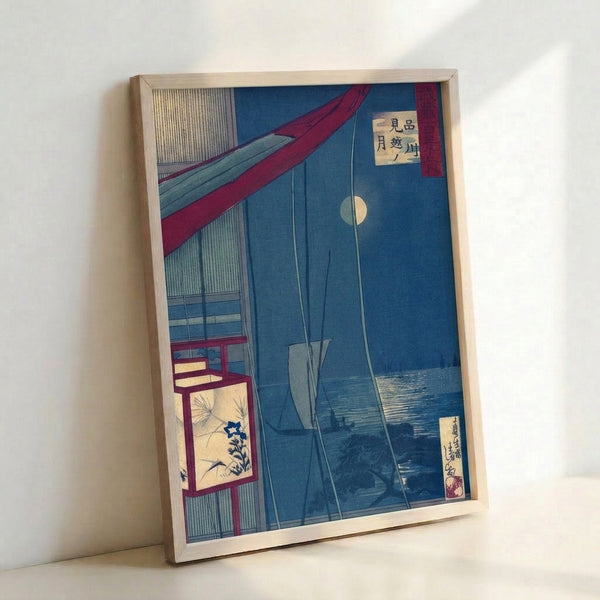 Framed vintage-style Japanese woodblock print of a moonlit harbor scene featuring a sailing vessel, warm lantern glow, and architectural elements in indigo, cream, and deep red hues.