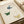 Scholarly Japanese-inspired poster showing a contemplative bird composition with monarch butterflies rendered in serene cream, deep blue, and terracotta accents.