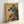 Japanese woodblock-style poster showing a rooster and hen nestled in grapevines with vibrant blue flowers and cream accents, evoking auspicious symbolism.