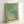 Meditative Japanese woodblock poster showcasing delicate crane imagery with enso circle design in earthy moss green and golden ochre hues.