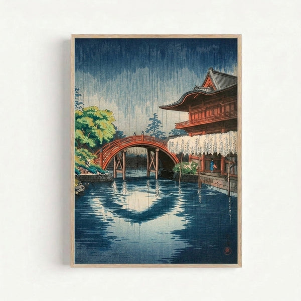 Contemplative framed poster of a Kyoto temple scene during rainfall, featuring a wooden bridge and surrounding trees in soft rust-red and yellow-green hues.