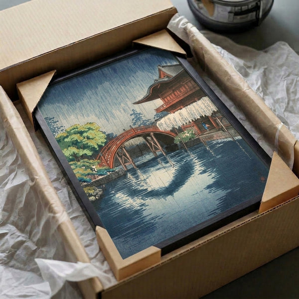Contemplative temple scene woodblock poster featuring rain, water, and bridge elements in the classic Japanese aesthetic, displayed as framed wall art with cool blue and warm accent tones.