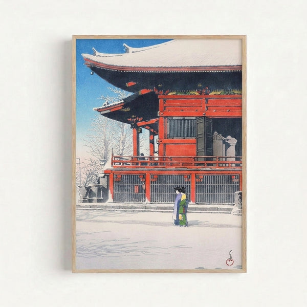 Vintage-style woodblock artwork depicting a temple building draped in snow with a contemplative figure in bright red robes, cool blue and white palette evoking winter stillness.