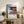 Contemplative Japanese woodblock art depicting a kimono figure at a snow-blanketed temple, cool cerulean and cream palette creating quiet, meditative atmosphere on framed poster.