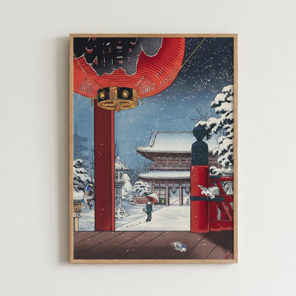 Contemplative Showa-era inspired art print showing a temple grounds blanketed in snow, featuring a glowing red lantern and figure beneath snow-laden branches in cool blue and white tones.