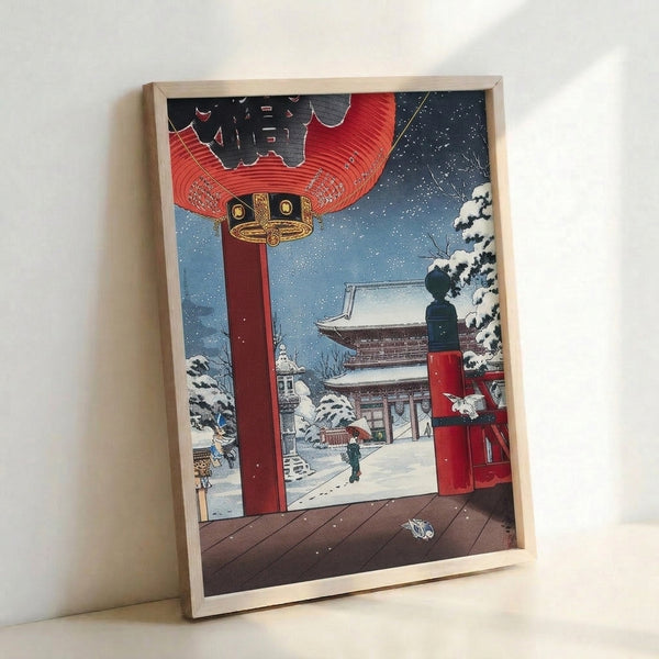Japanese winter temple print in traditional woodblock aesthetic, capturing a snowy landscape with red-lit lantern, architectural gateway, and lone person amid frost-covered trees.