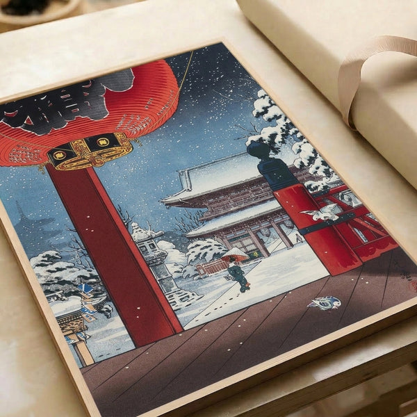 Peaceful winter landscape in Japanese woodblock tradition showing a temple nestled in snow with crimson lantern, shadowed gate structure, and solitary figure among trees.