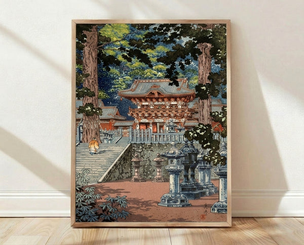 Serene Japanese woodblock print of Nikko Toshogu Temple Gate featuring a robed monk ascending stone steps through a forested courtyard with lanterns and warm earth tones.