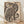 Japanese woodblock print featuring a striped tiger with playful whimsy, accompanied by a bird and monkey in folk art style, rendered in cream, black, and ochre tones.