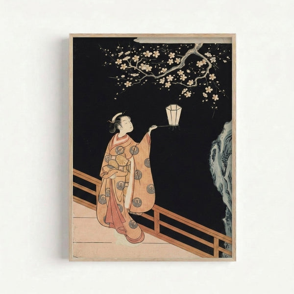 Framed Japandi art print showing a solitary figure with lantern gazing upward at blooming cherry branches, executed in traditional woodblock style with pale blue and cream palette.