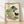 Framed Japanese watercolor art print depicting a woman in traditional dress sorting fresh vegetables and leafy greens among woven baskets, rendered in soft sage green, pink, and terracotta tones with black ink details in a folk art style.