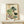 Gentle Japanese woodblock-inspired watercolor poster showing a humble market vendor arranging produce including radishes and greens, with warm cream and soft pink hues evoking a peaceful domestic scene.
