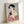 Traditional Japanese art print depicting a geisha with brush and mirror, painted in rich jewel tones of red and green with gold flourishes in the woodblock aesthetic.