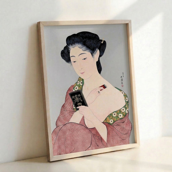 Traditional Japanese art print depicting a geisha with brush and mirror, painted in rich jewel tones of red and green with gold flourishes in the woodblock aesthetic.