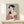 Serene portrait of a woman in elaborate kimono holding a mirror, executed in the Japanese woodblock tradition with cream, black, and metallic gold highlights creating an elegant, refined composition.
