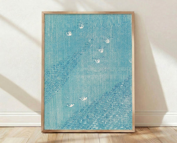 Serene Japanese woodblock print featuring birds flying over stylized turquoise waves, rendered in minimalist style with cream and white accents; framed poster hung on wall.