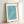 Contemplative Japanese-inspired woodblock print showing birds in flight above flowing turquoise and white waves; framed artwork with zen-like composition.