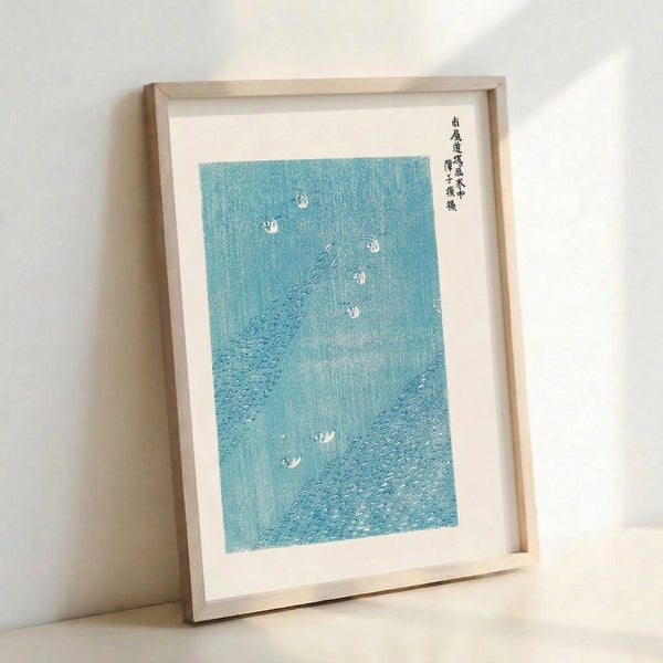 Contemplative Japanese-inspired woodblock print showing birds in flight above flowing turquoise and white waves; framed artwork with zen-like composition.