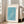 Calm woodblock-style poster art of birds soaring over layered teal waves, using minimal palette of turquoise, cream, and white; framed as wall decor.