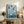 Japandi-style framed artwork of mallard ducks and ornamental koi navigating a serene lily pond in soft yellow, blue, and muted green tones.