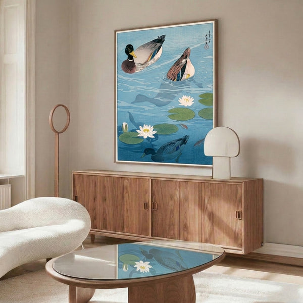 Framed decorative print in the style of Japanese woodblock art showing peaceful ducks and koi in a lotus pond landscape with a harmonious palette of teals, creams, and olive accents.
