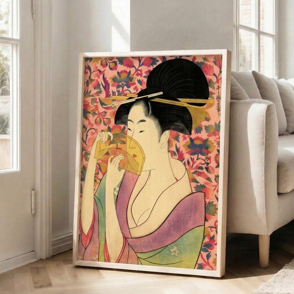 Feminine Art Nouveau interpretation of a geisha in soft gold and coral pink tones, with floral motifs and traditional accessories, displayed as a framed art print.